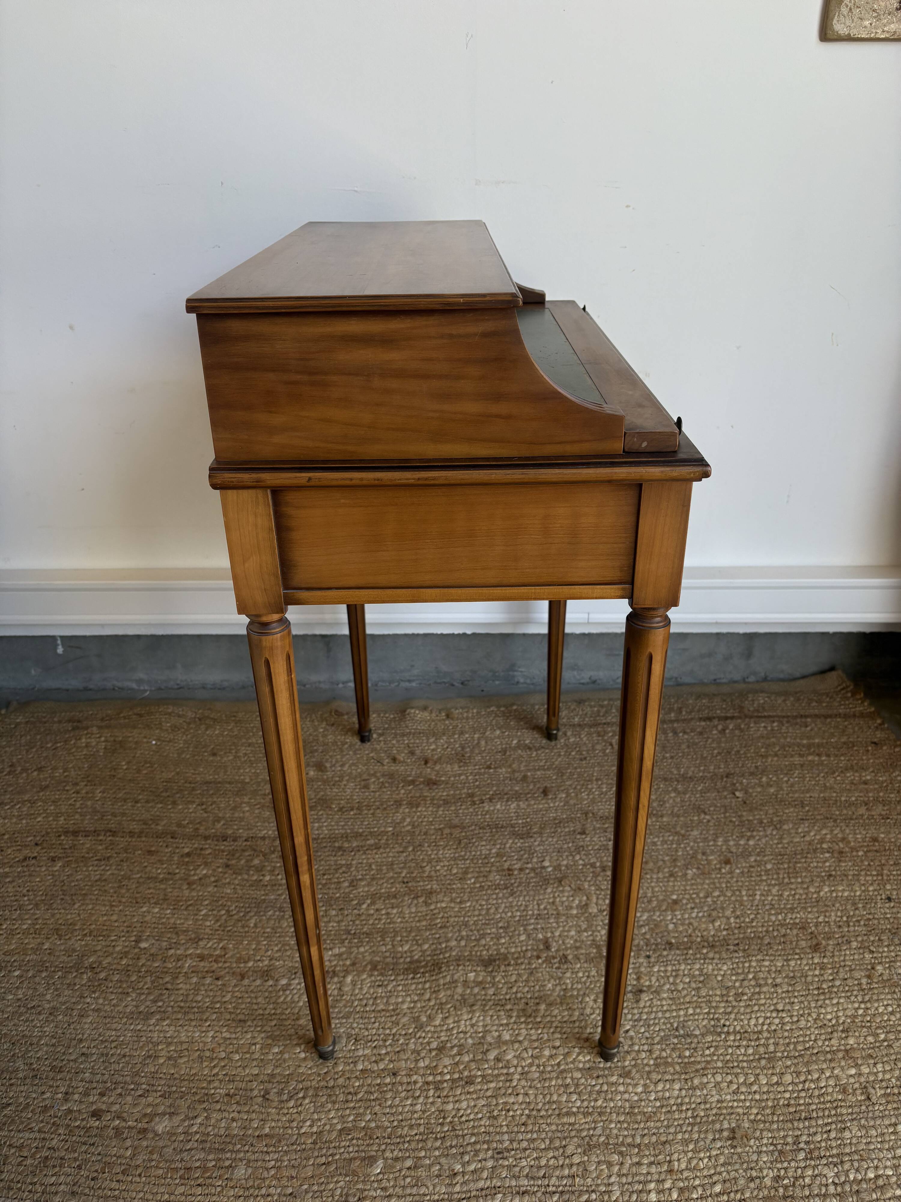 Louis XVI style mahogany telephone table with a green leather top.