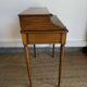 Louis XVI style mahogany telephone table with a green leather top.