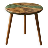 Round resin coffee table with a natural edge.