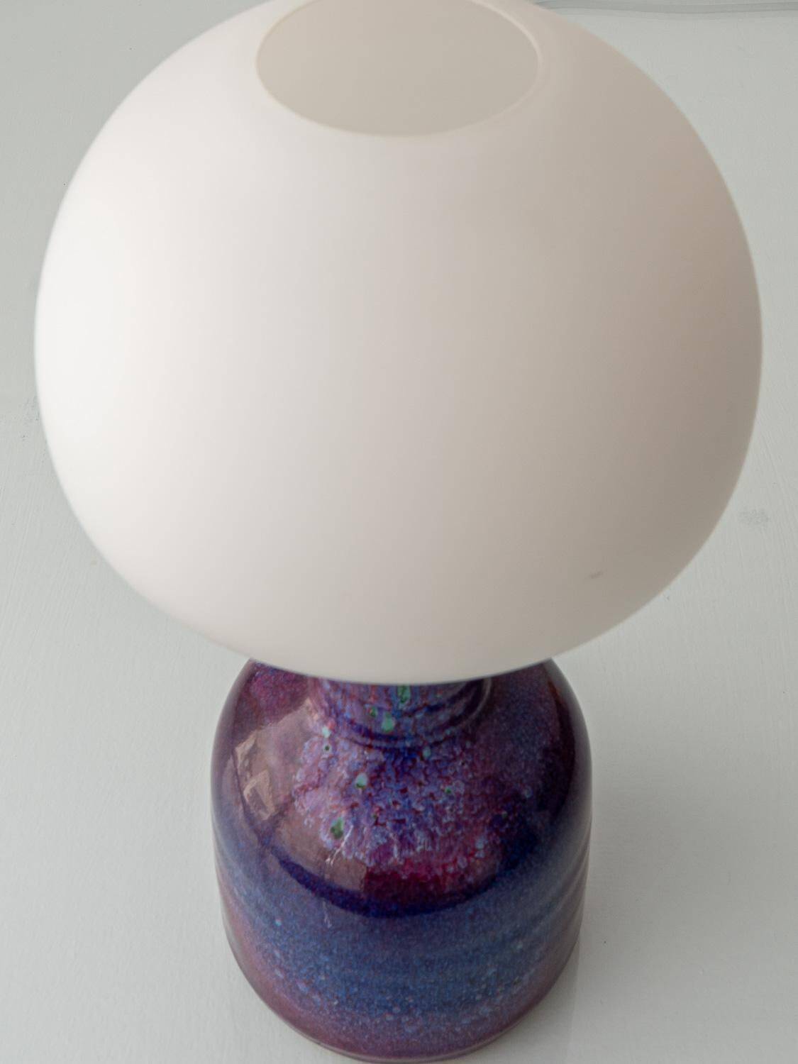 Mid-century modern table lamp by Jaap Ravelli, ceramic base and glass shade.