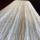 Beige marble stucco base, Houles white ecru fringed lampshade.