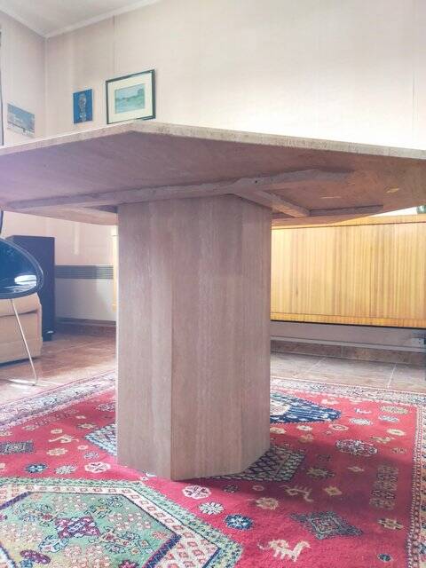 Octagonal dining table in travertine