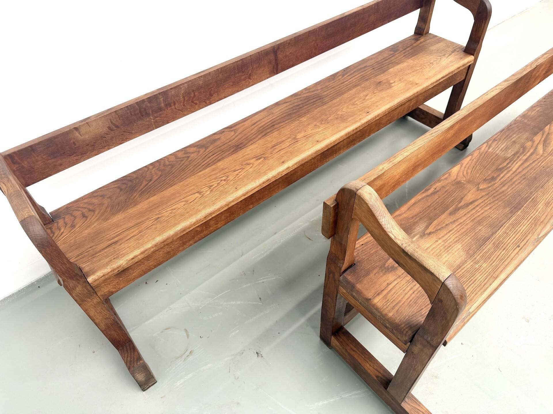 Pair of communal benches in solid oak, 1950s.