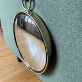 Vintage witch's eye curved mirror hangs velvet ribbon