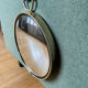 Vintage witch's eye curved mirror hangs velvet ribbon