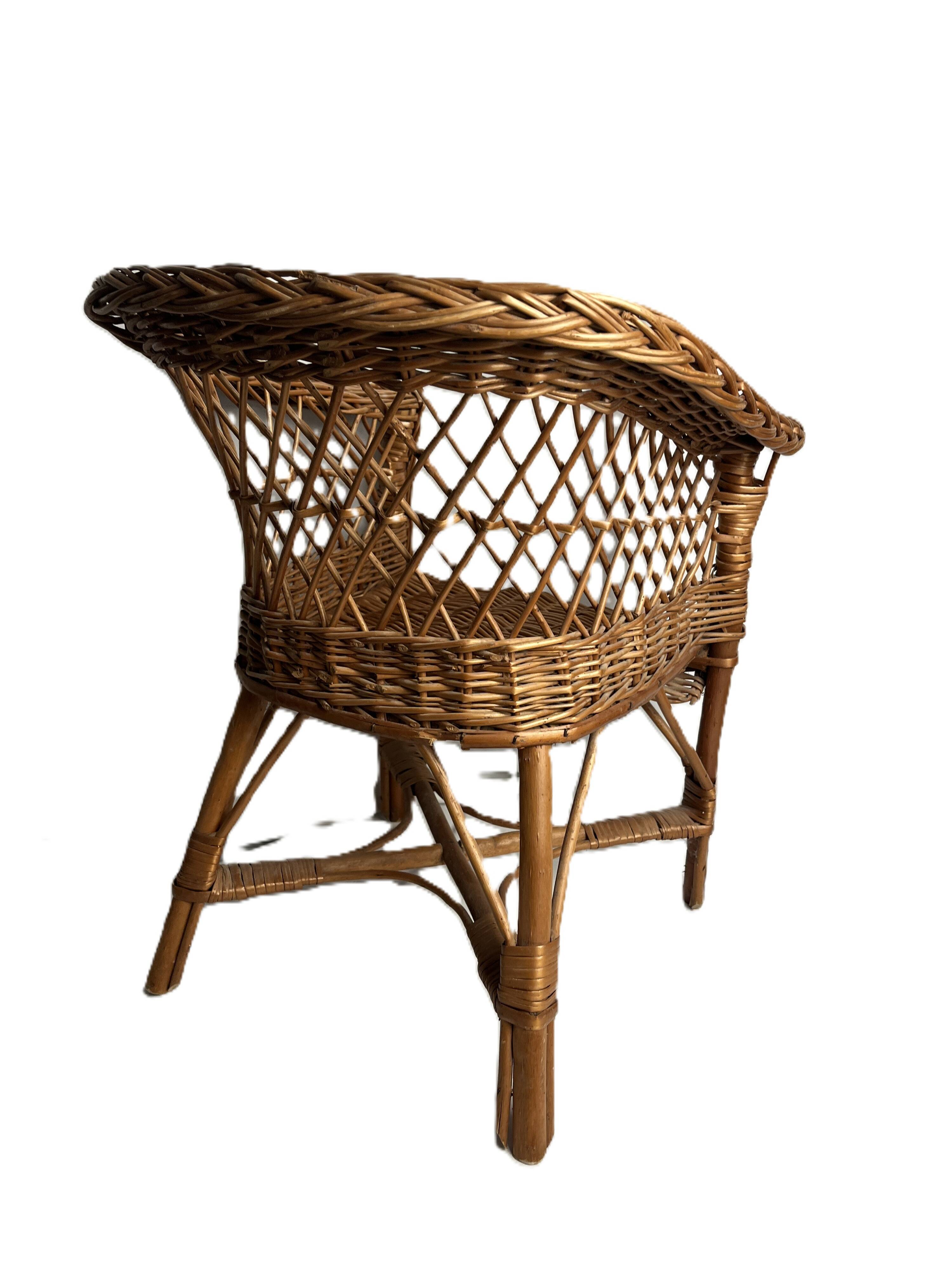 Vintage, children's armchair in woven rattan from around 1970.
