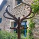 dark-coloured wooden coat rack parrot