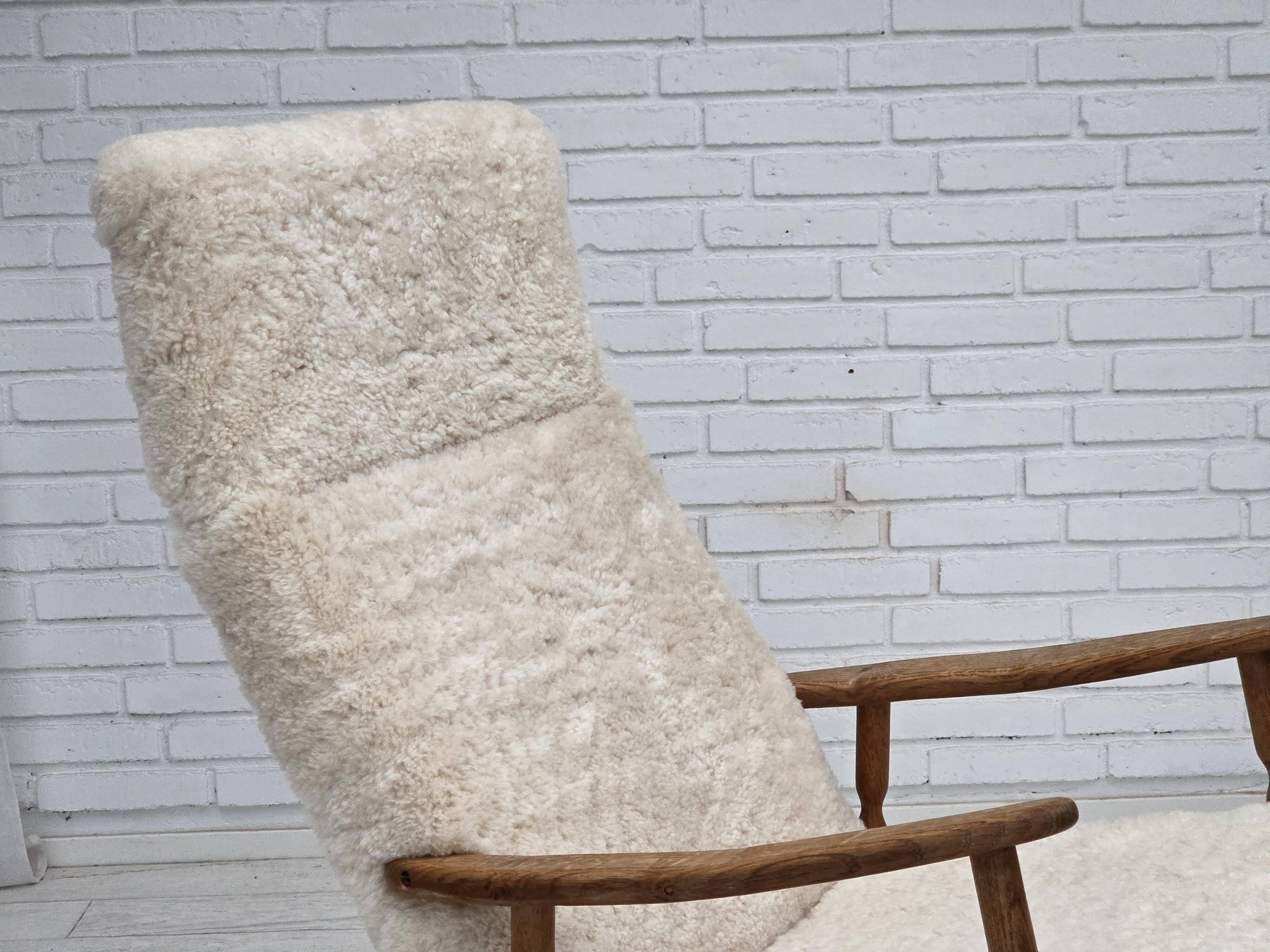 1970s, Danish rocking chair, reupholstered in quality genuine sheepskin.