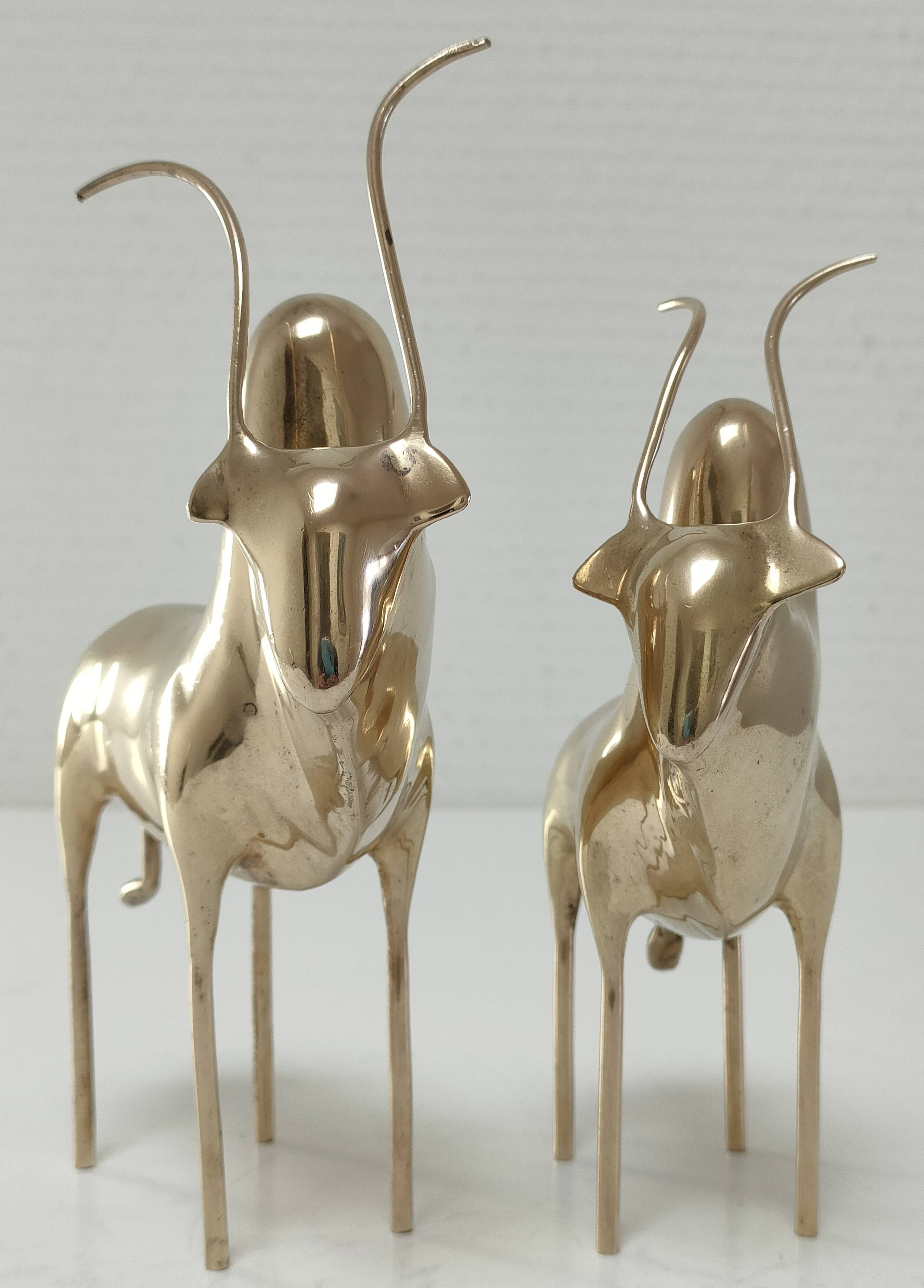 Two stylized zebu with long vintage brass horns