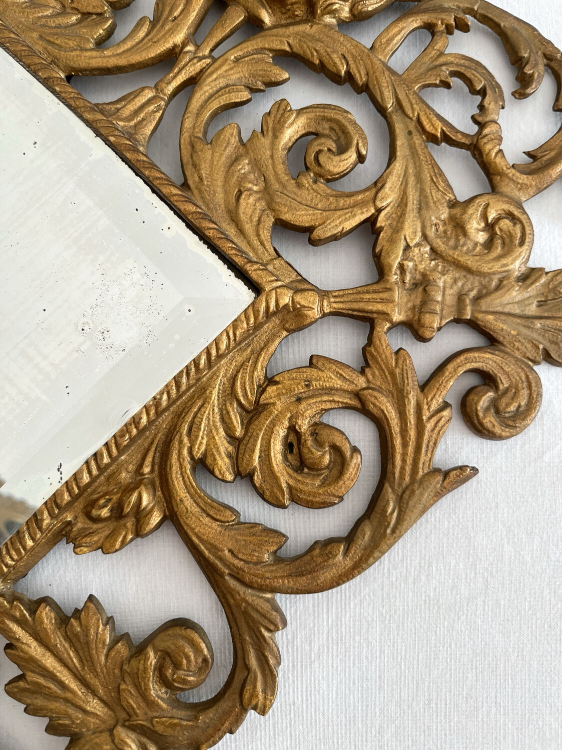 Bevelled mirror wall sconce in gilded bronze with 3 candle holders.