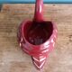 Poet Laval swan hides zoomorphic pot in burgundy ceramic.