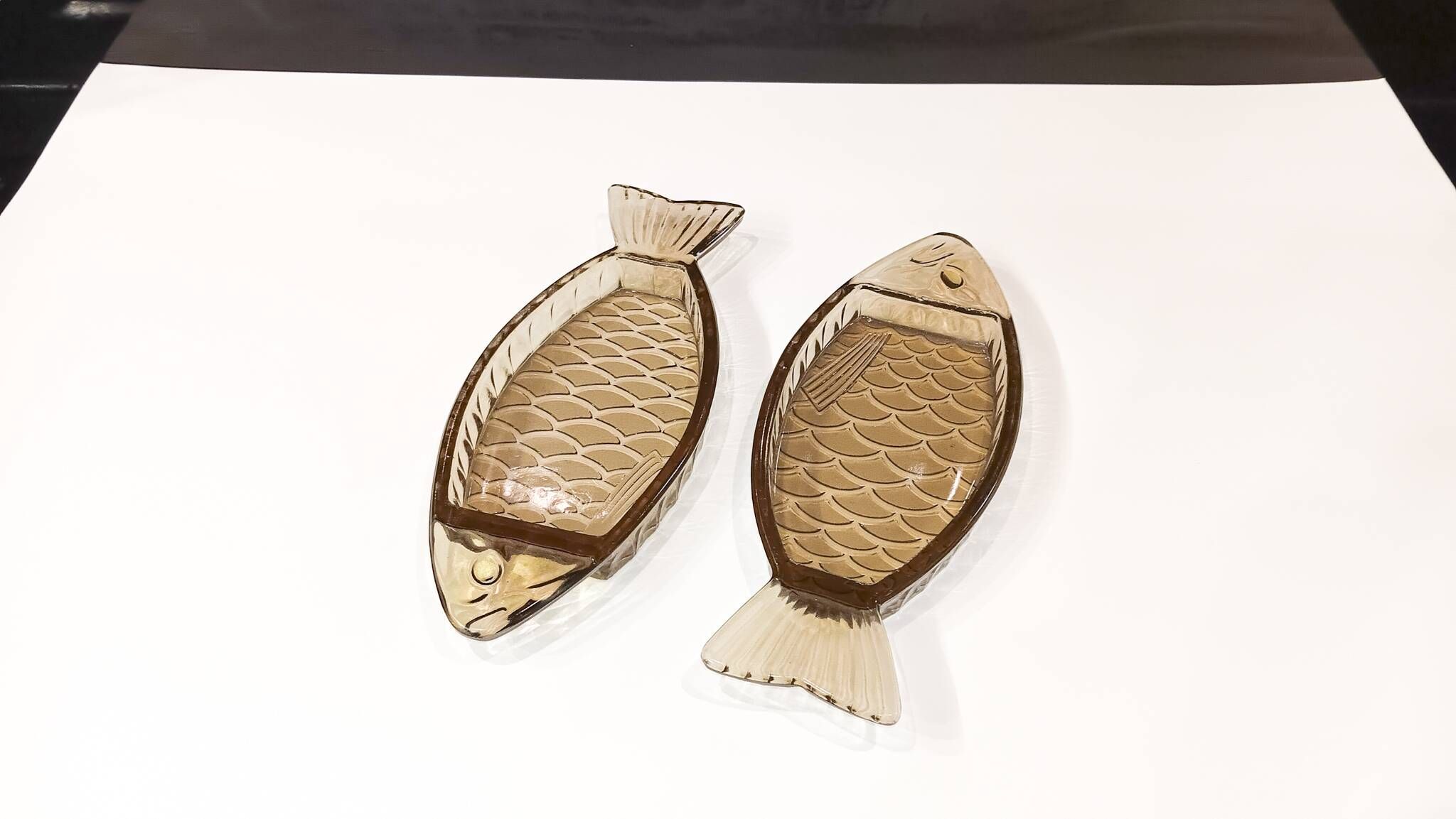 Set of 2 transparent smoked glass bowls in the shape of a fish.