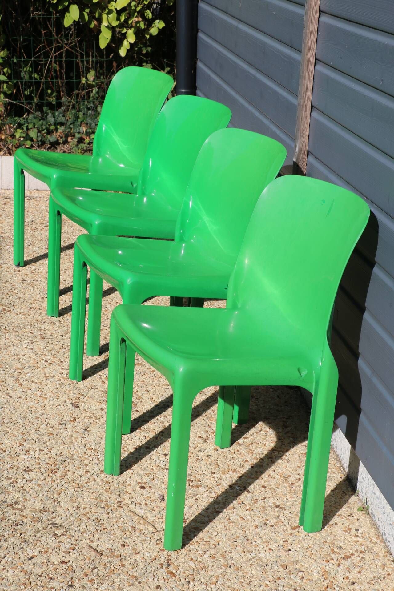Set of 4 green Selene Magistretti chairs.