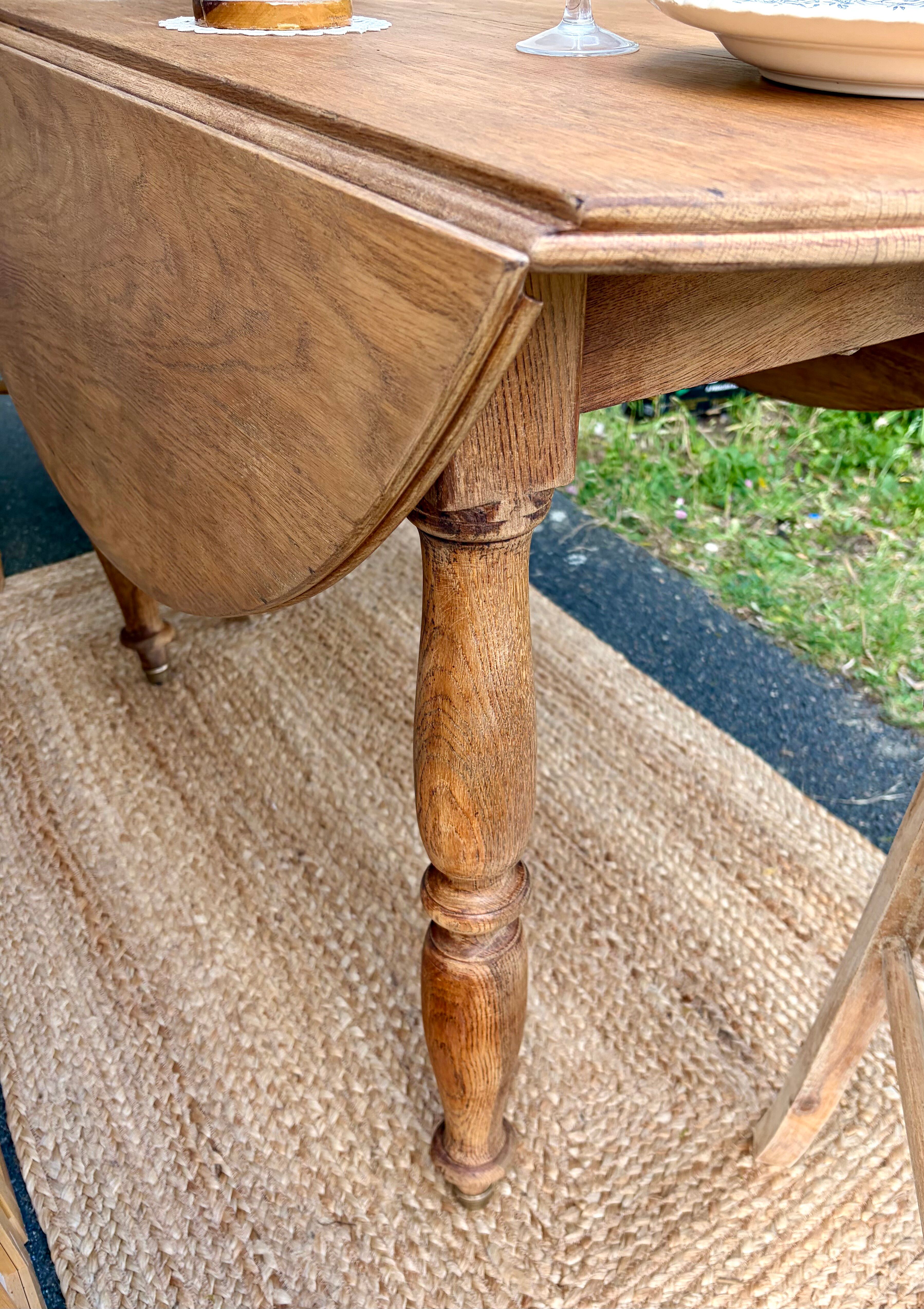 Round oak table with a drop leaf.