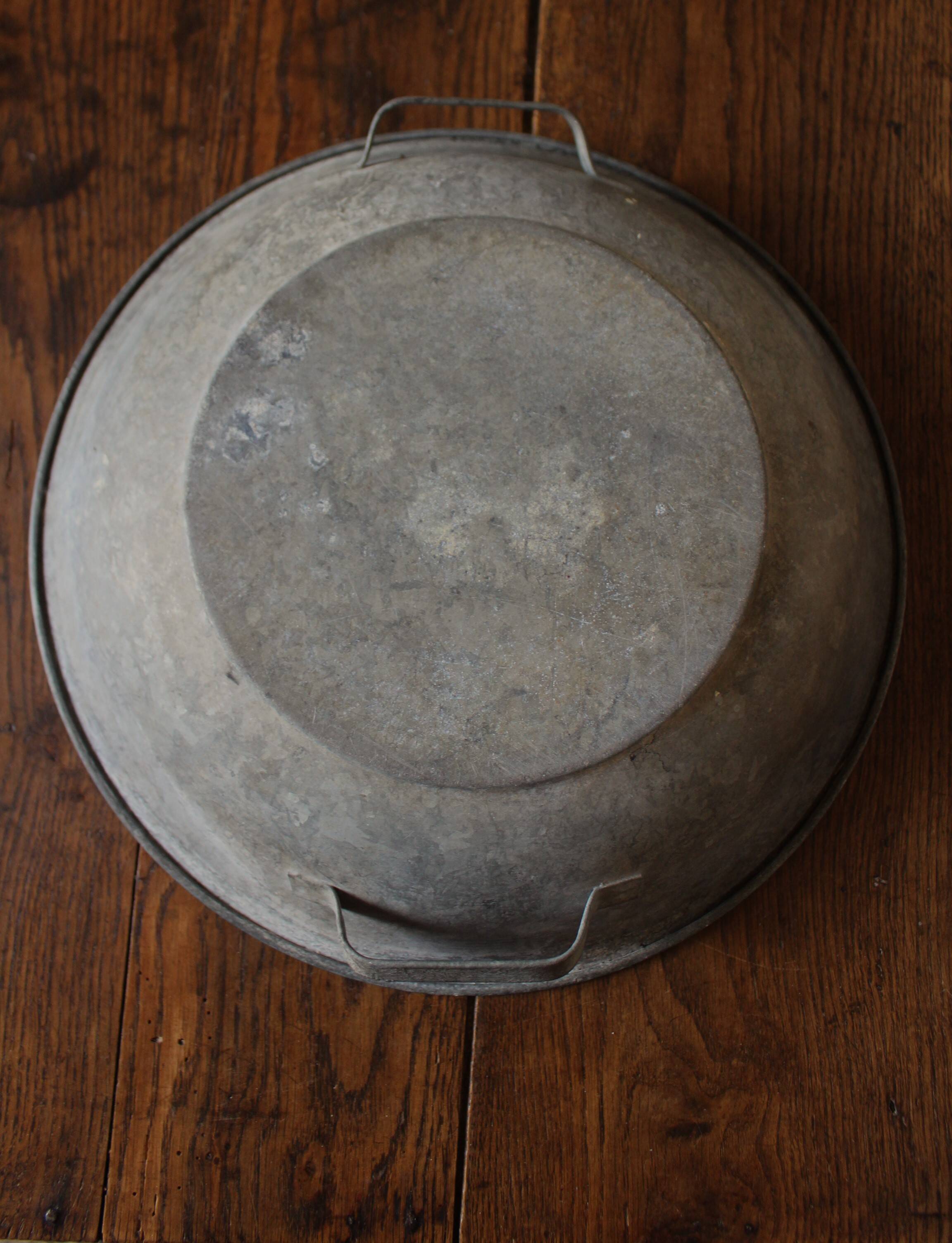 Round zinc basin planter with two handles underneath