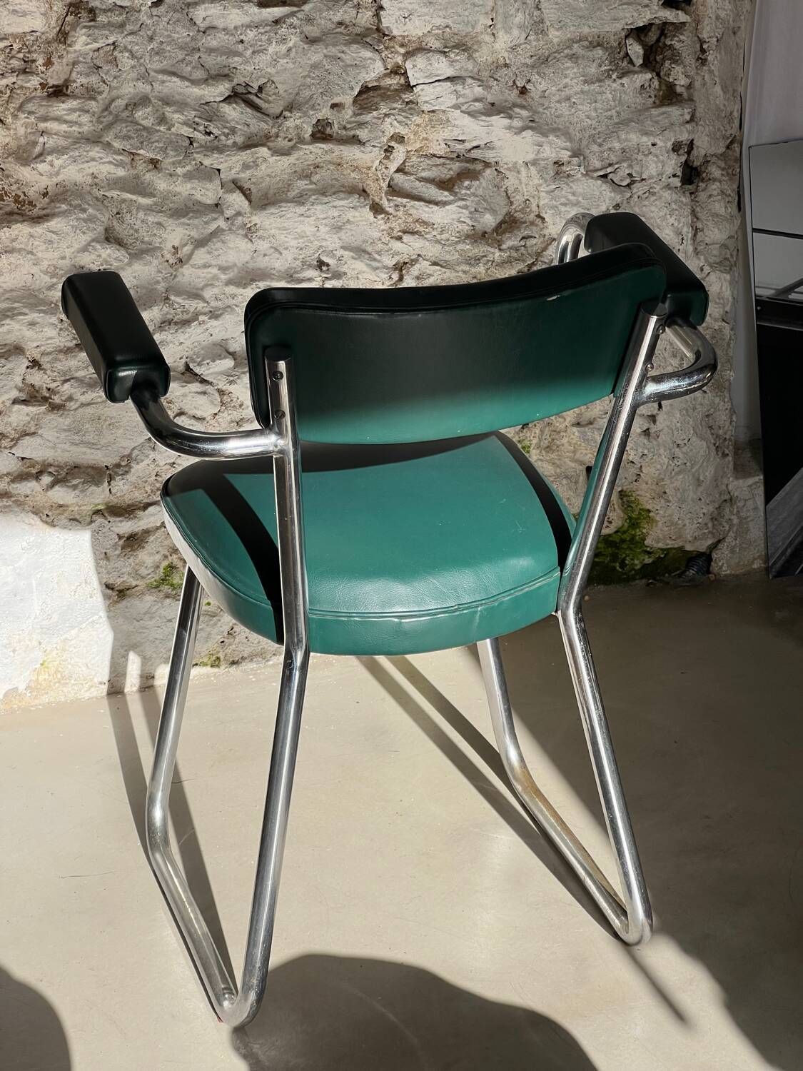 Pair of green vinyl and chrome armchairs, mid-century