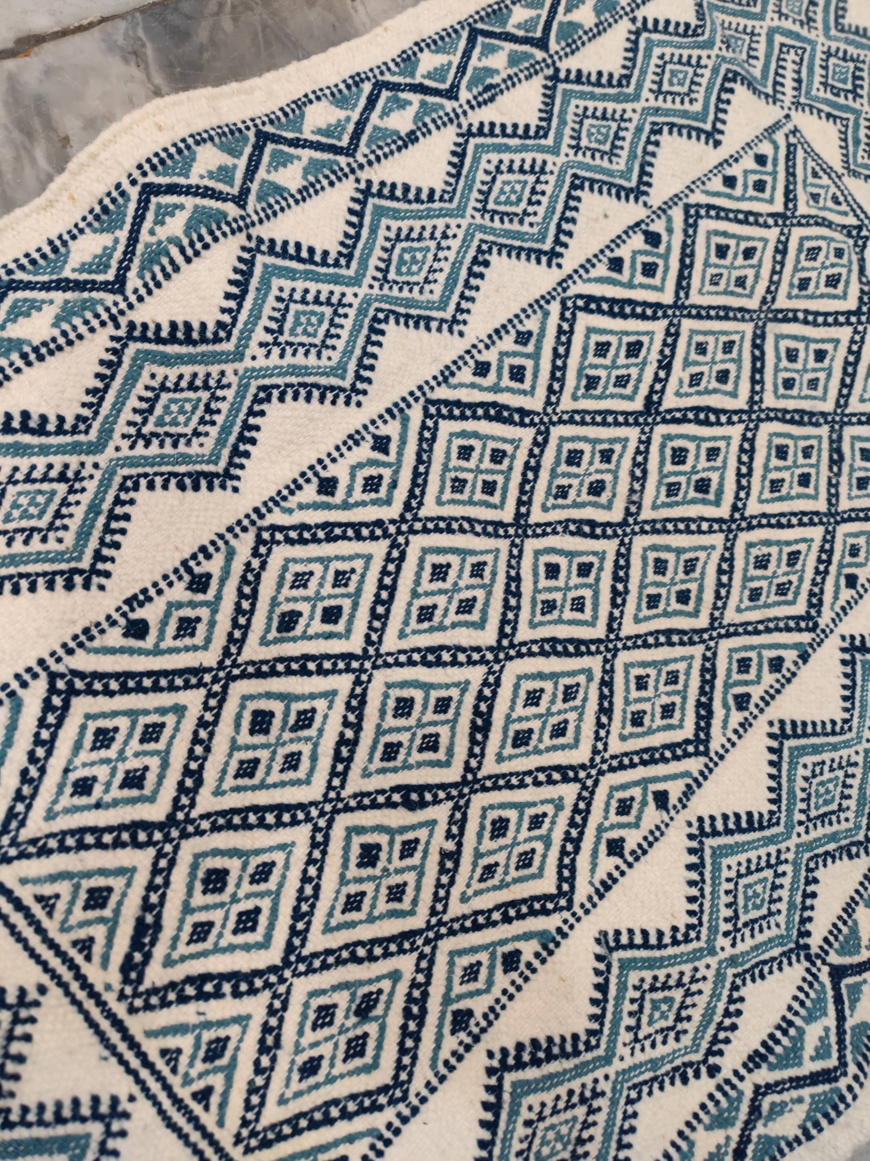 White and blue hand-woven rug in natural wool