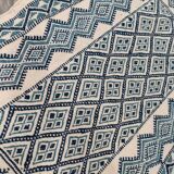 White and blue hand-woven rug in natural wool