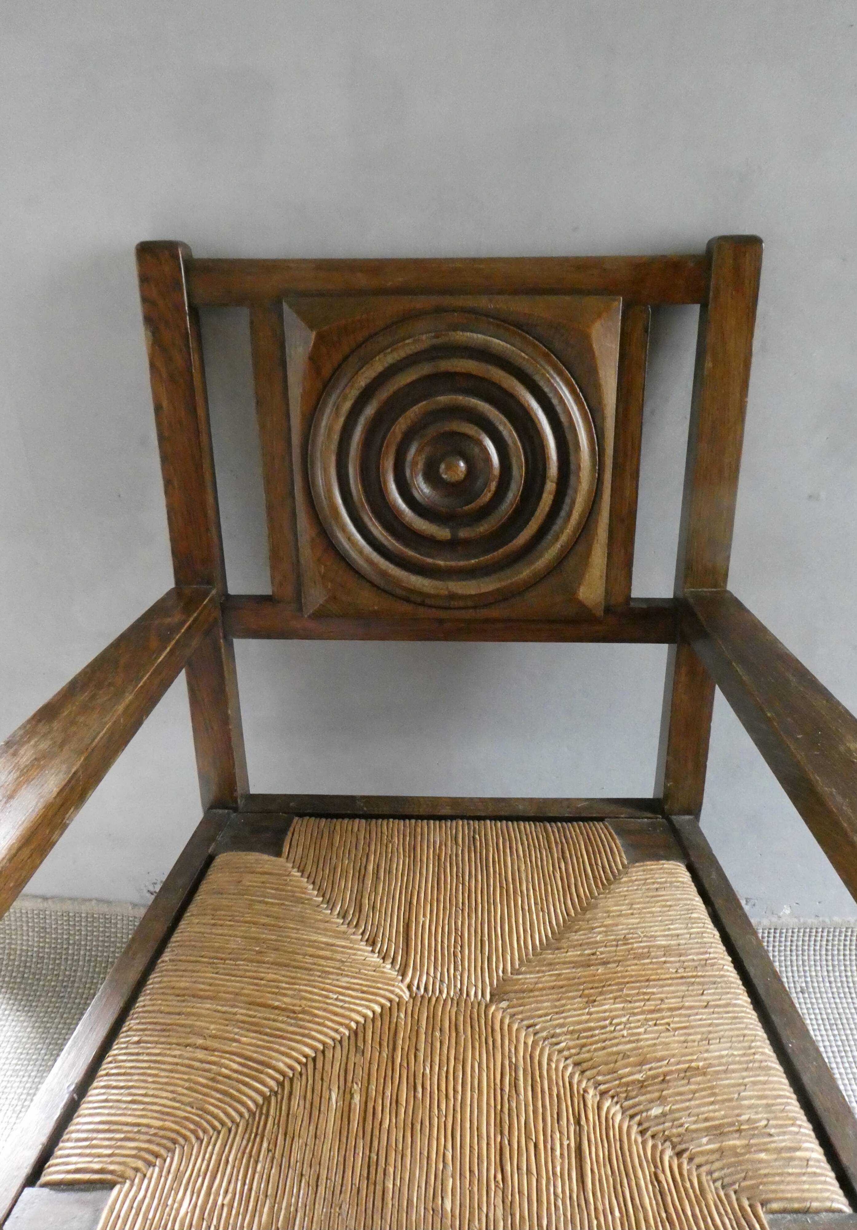 Armchair in carved solid wood with straw seat