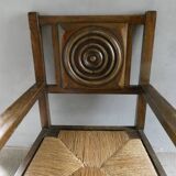 Armchair in carved solid wood with straw seat