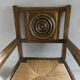 Armchair in carved solid wood with straw seat