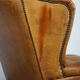 Positively lived-in sheepskin leather wing chair with pleasant seating comfort