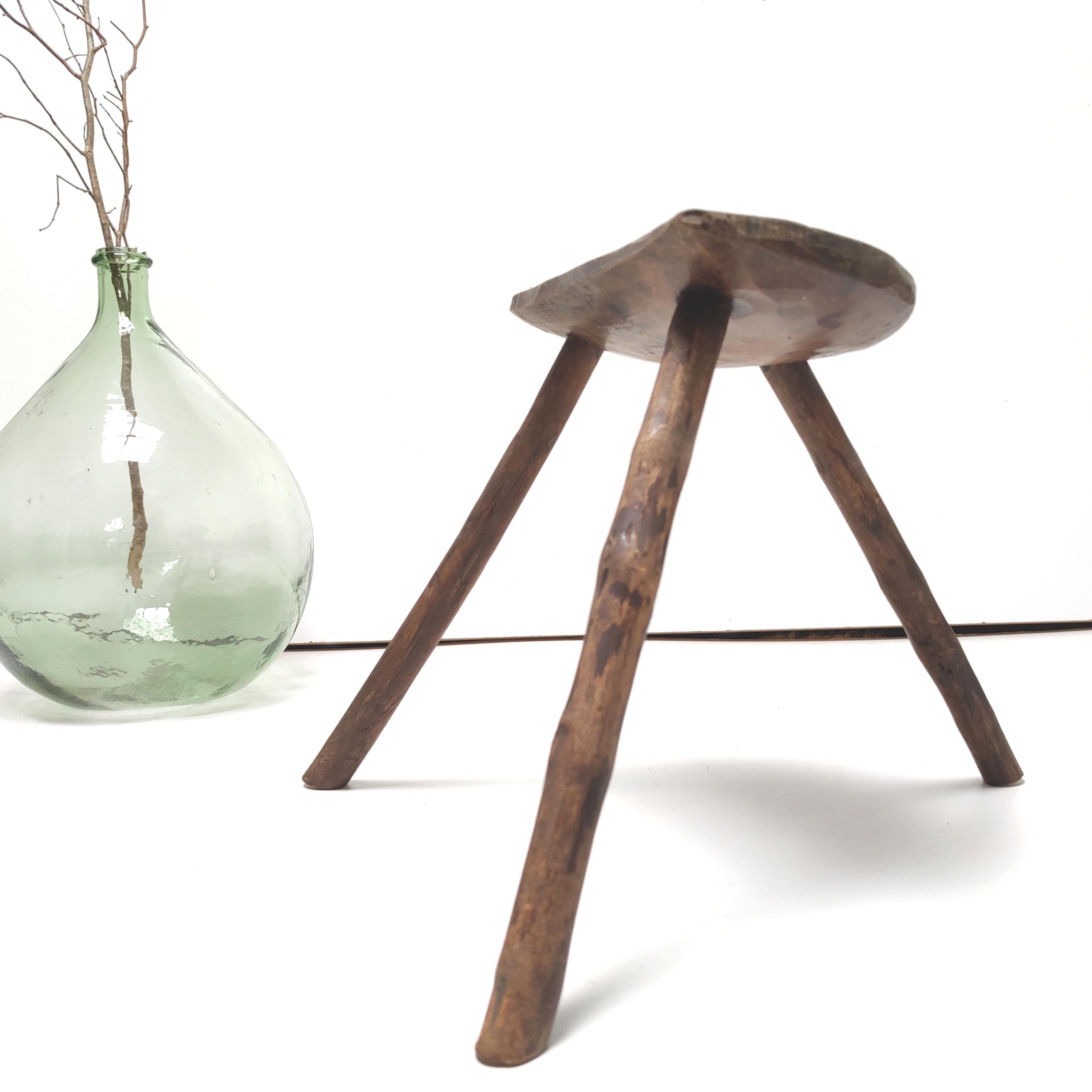 Brutalist tripod stool in solid wood half round