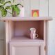 Antique bedside table revamped in pink.