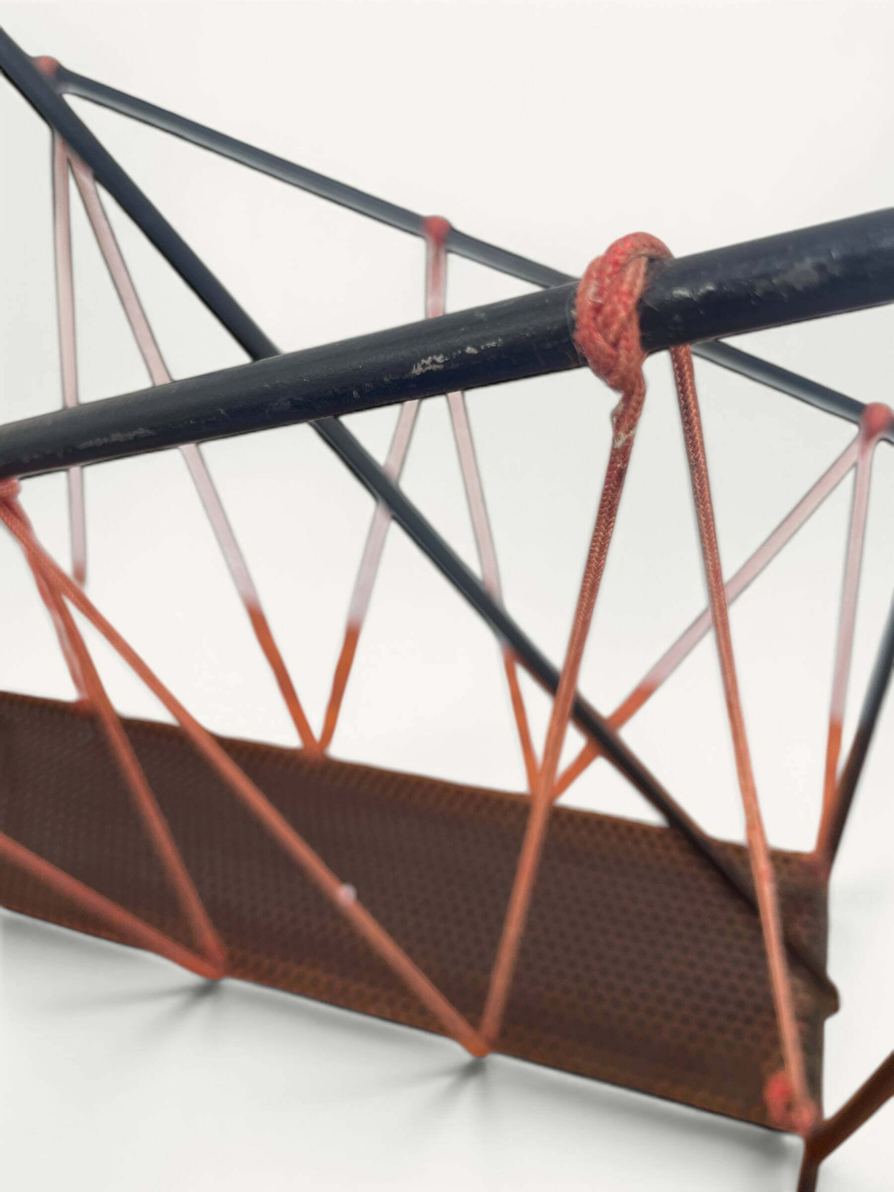 Vintage perforated metal magazine rack with cord handles by Matégot from the 1950s-60s.