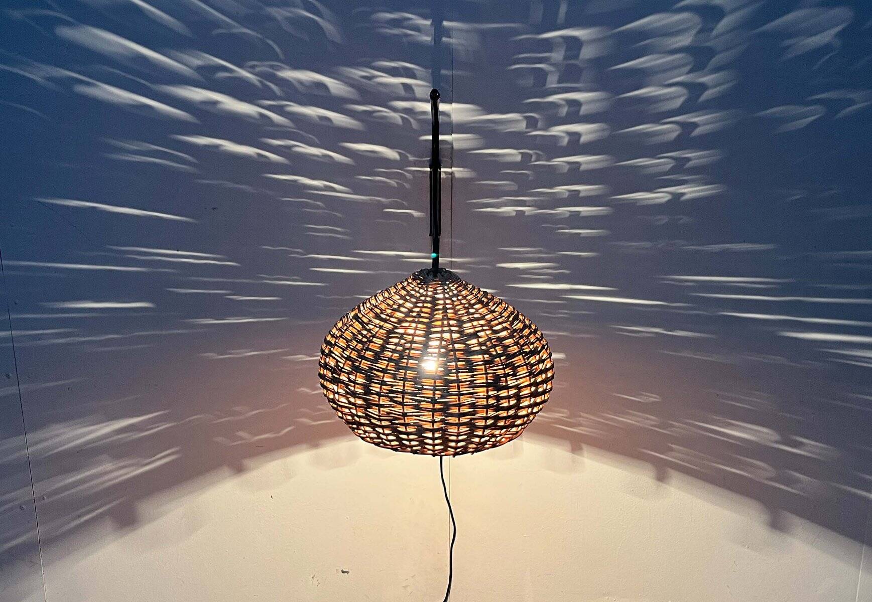 Mid-century modern Danish extendable cantilever wall lamp with a rattan shade, 1960s.