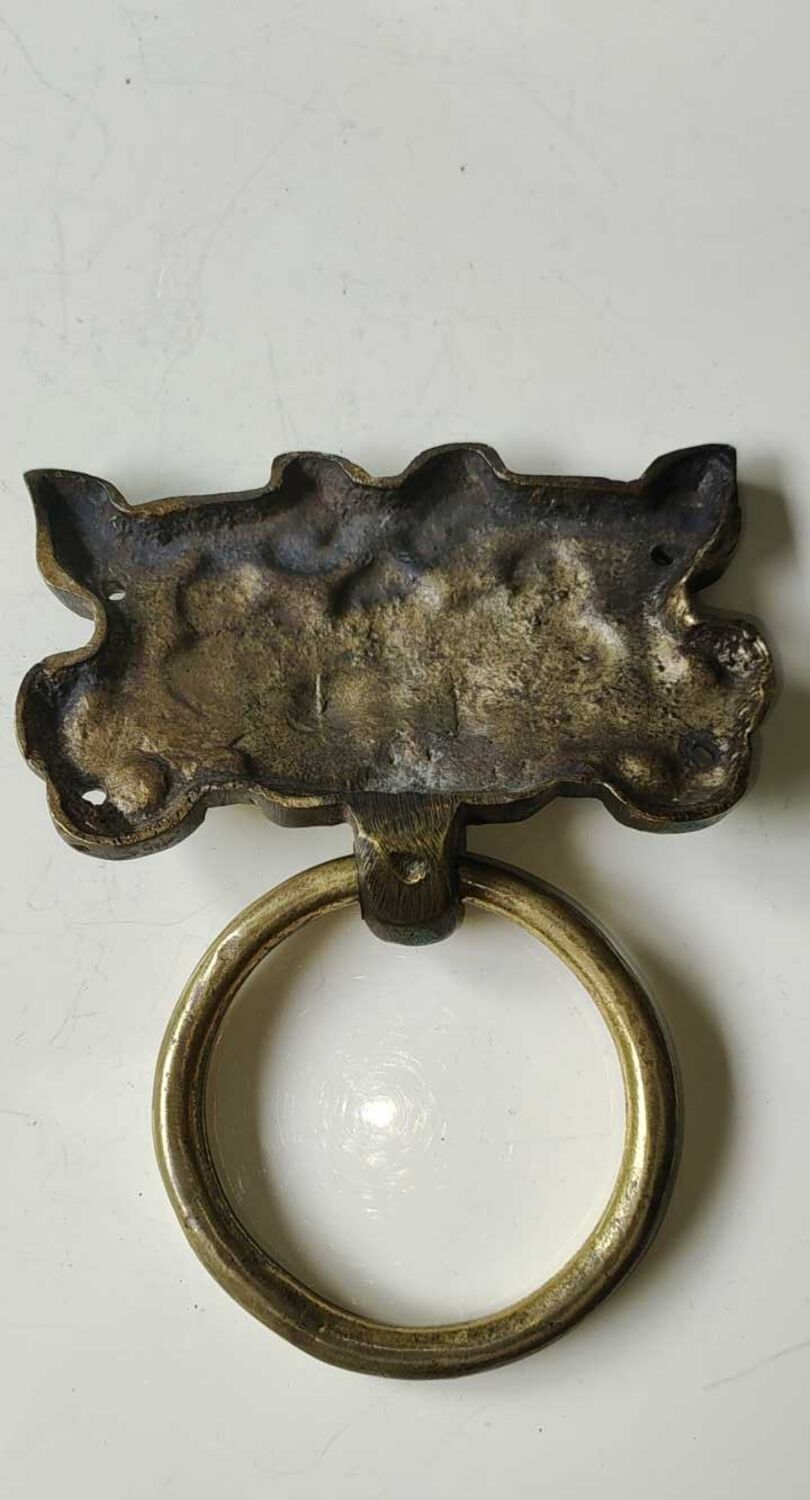 Ancient door knocker, taotié mask, shang dynasty. in bronze golden patina
