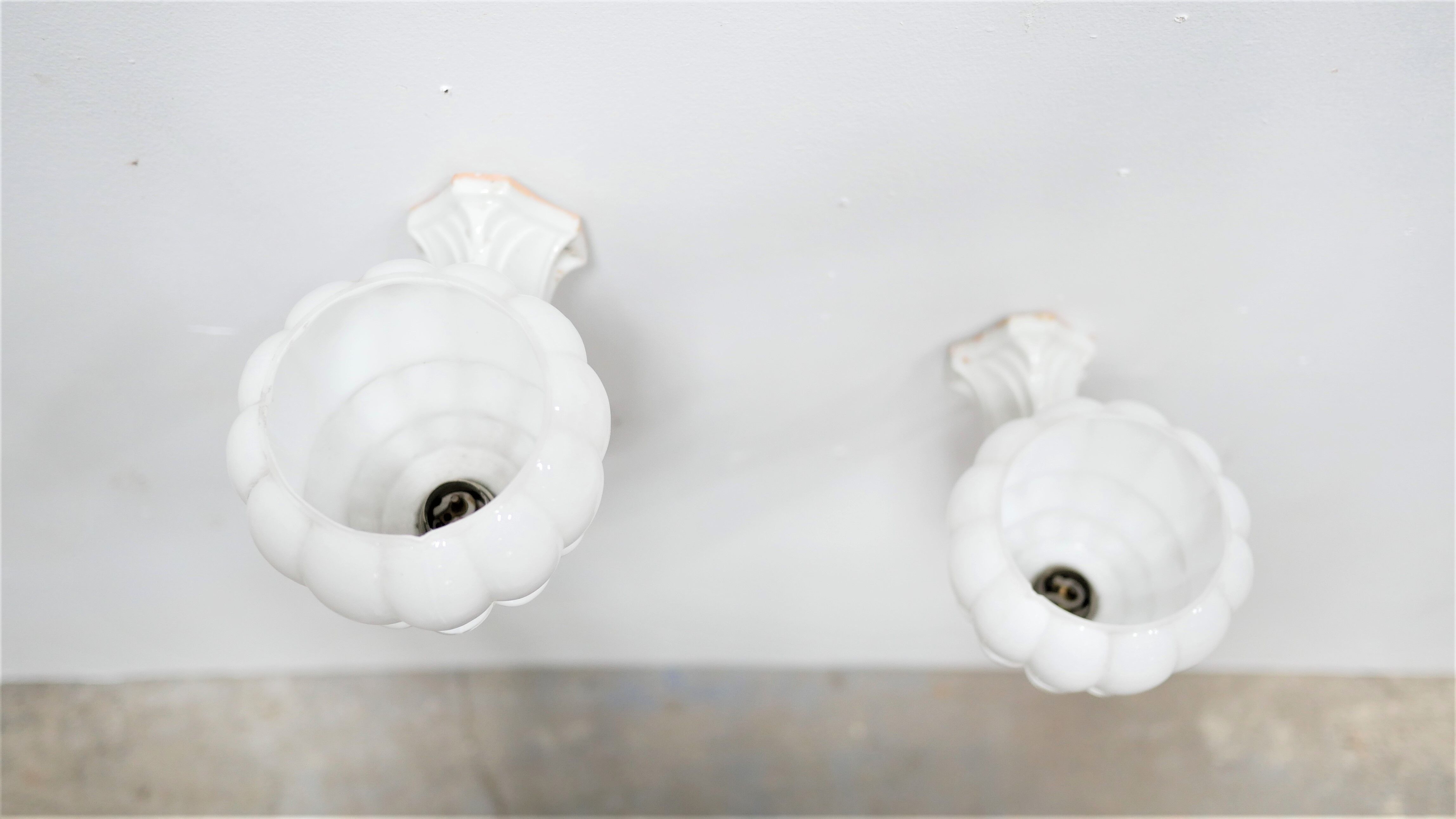 Pair of art deco porcelain and glass wall appliques