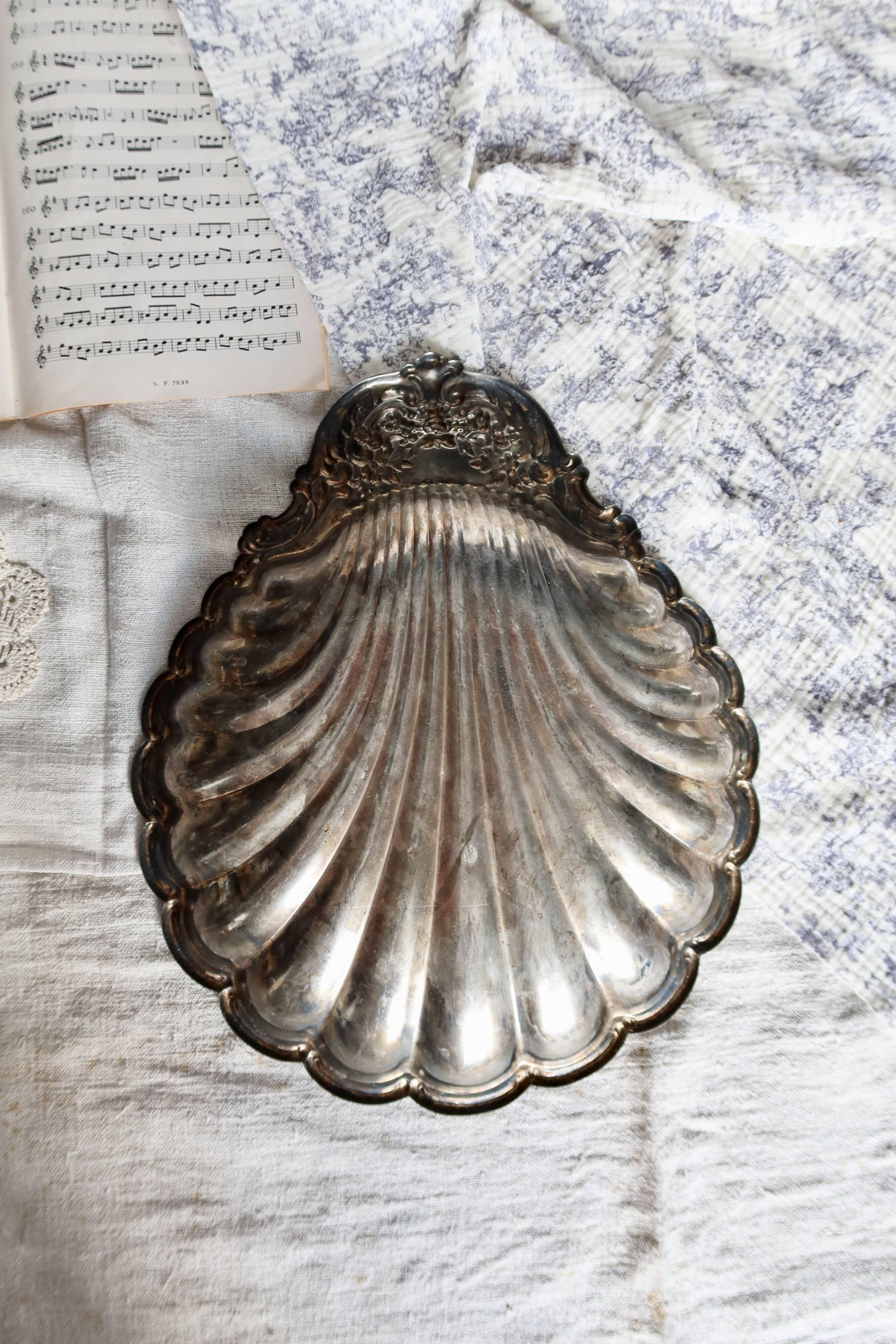 Large vintage shell-shaped platter in shiny silver-plated metal.