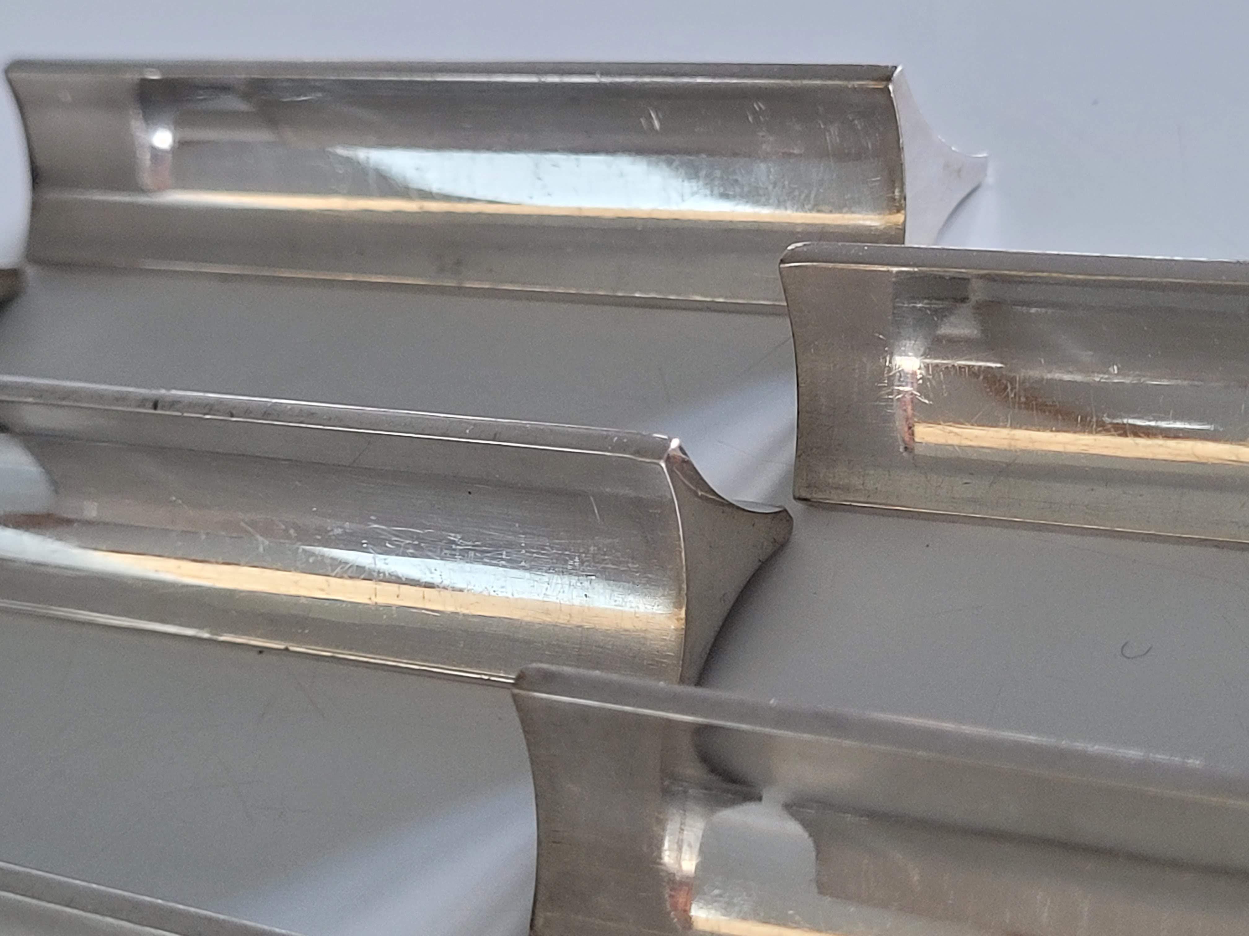 Eight Boulenger knife holders in art deco silver metal