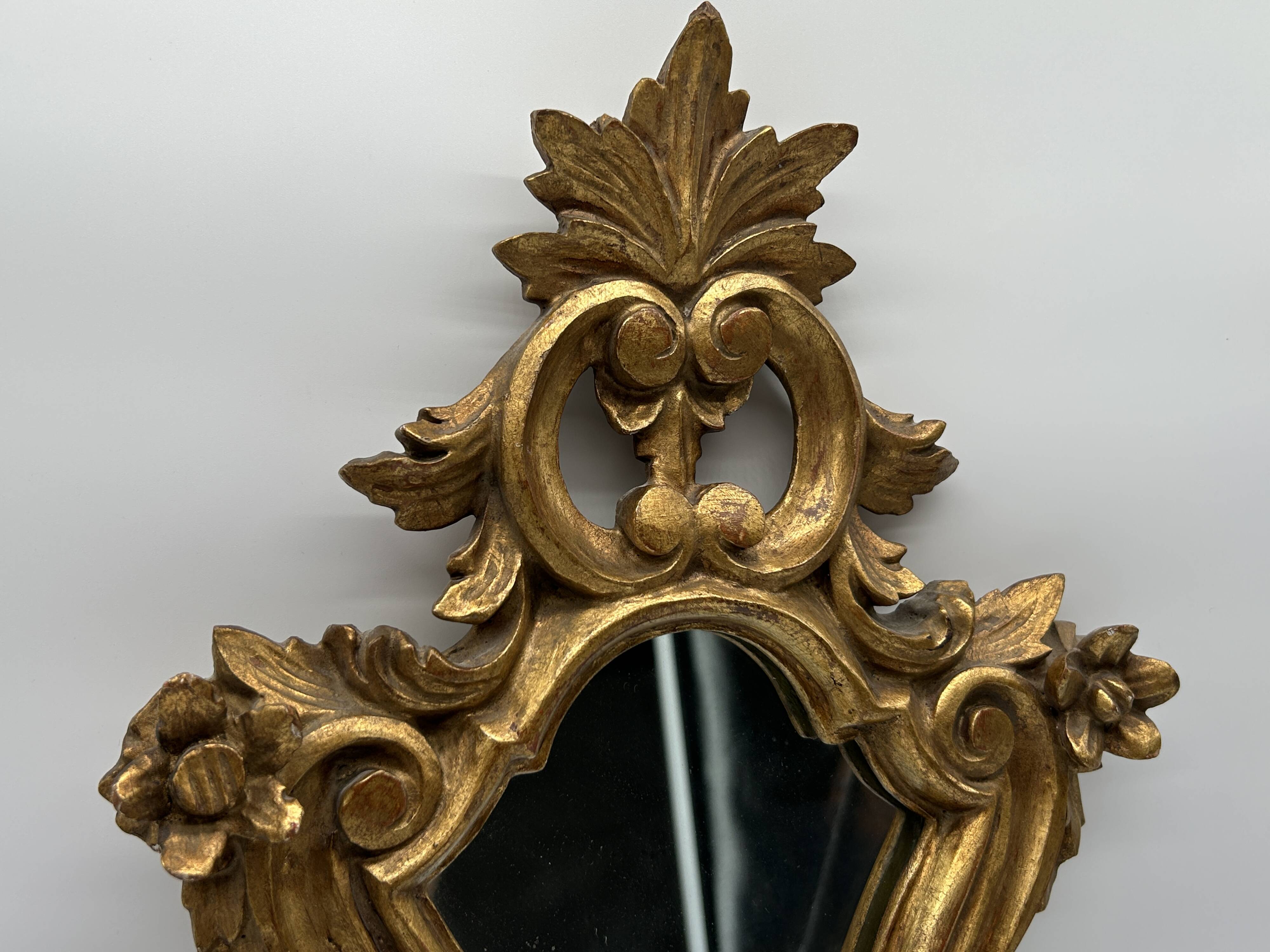 Wooden mirror with gilded stucco
