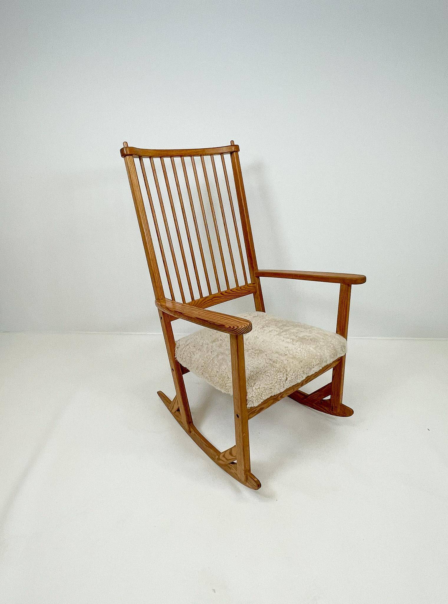 Mid-century rocking chair in pine and sheepskin by Yngve Ekström, Sweden.