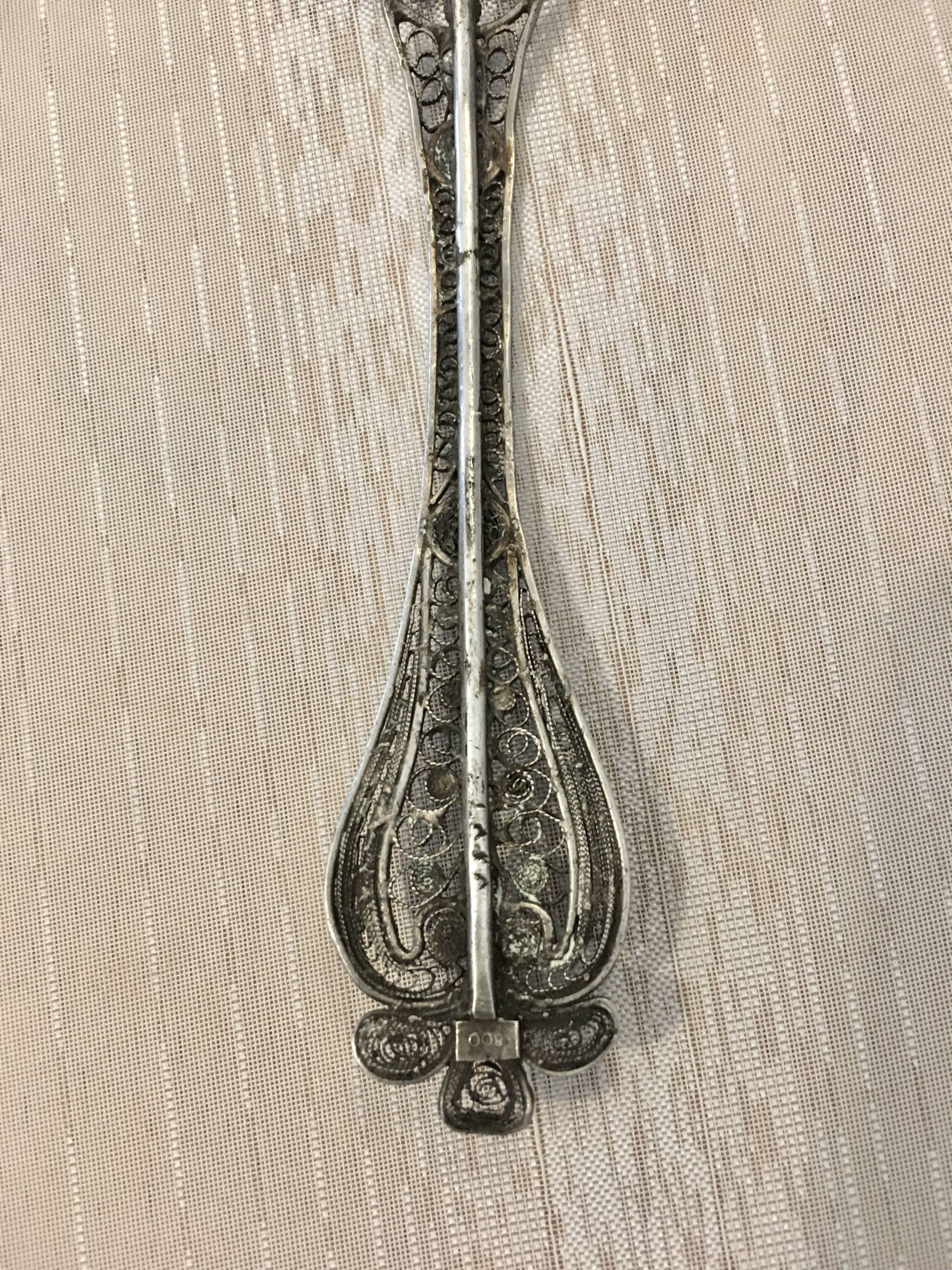 silver sprinkler spoon