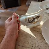 11 dinner plates, one large oval dish, and one gravy boat.