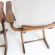 Pair of varnished wooden reclining armchairs, upholstered in lightweight fabric.