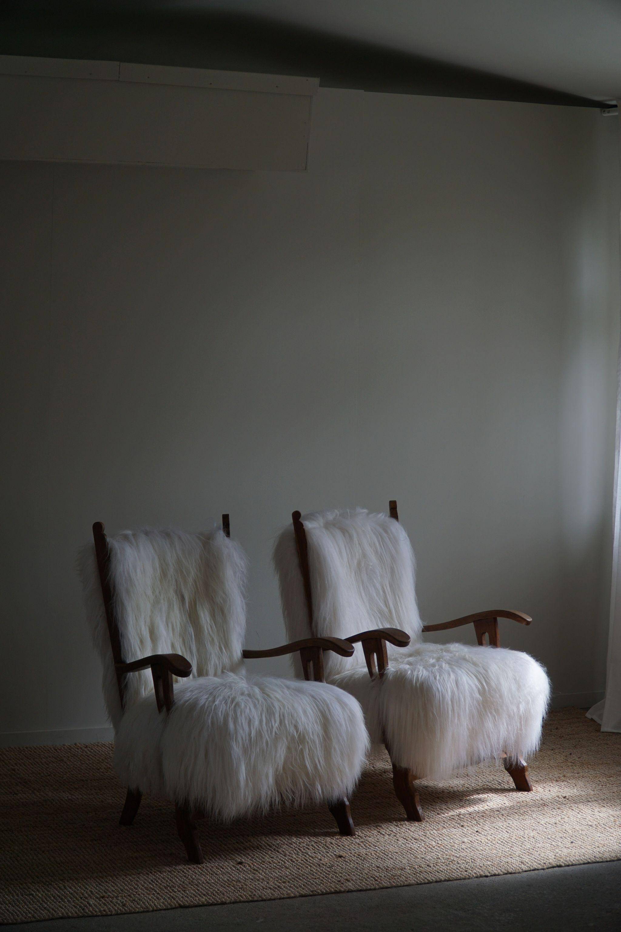 Pair of Scandinavian armchairs in oak and long-haired Icelandic sheepskin by Henning Kjærnulf, 1950.