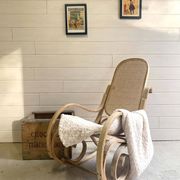 Rocking chair with a cane seat and backrest.