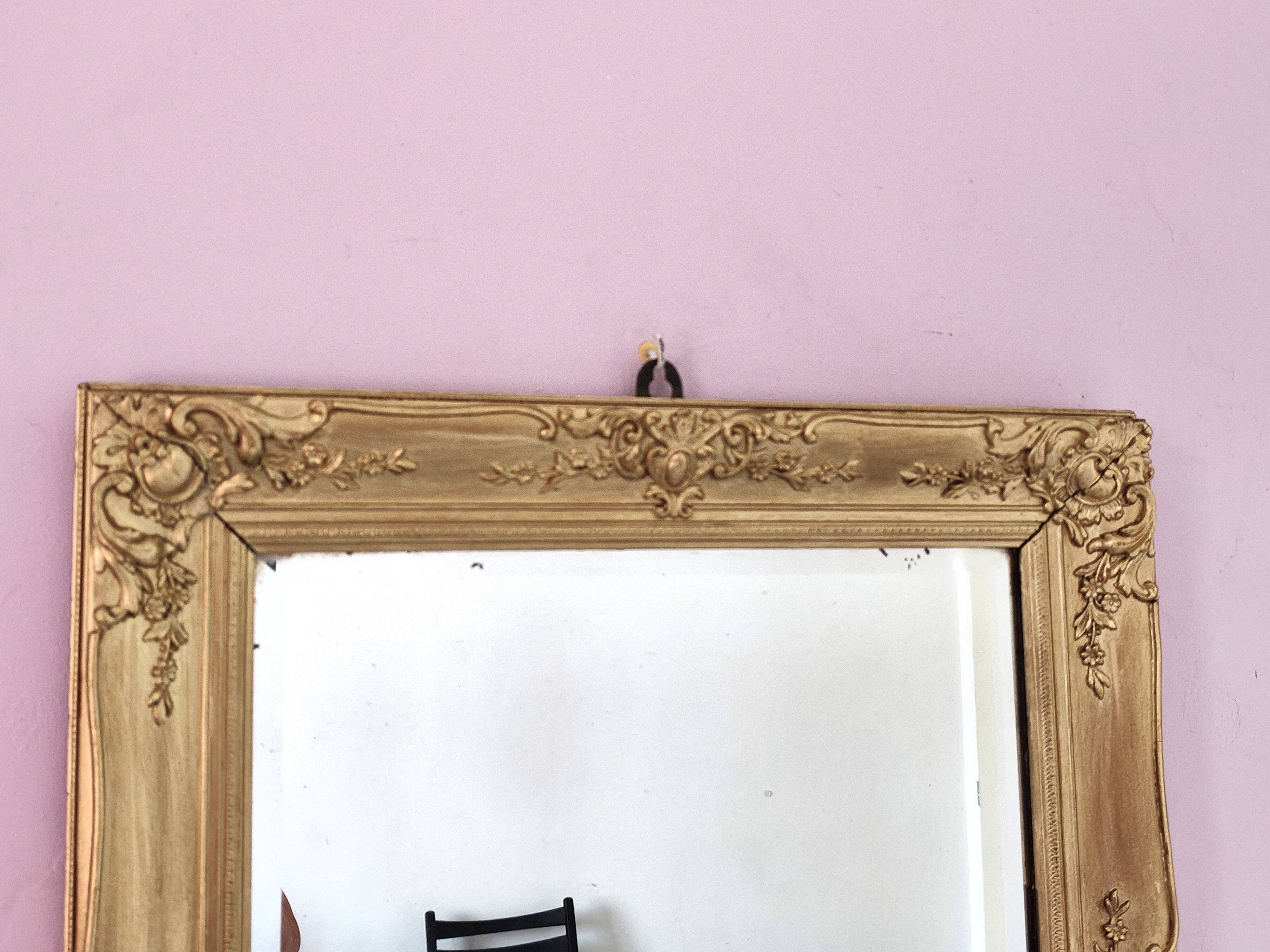 Richly carved antique gilded mirror