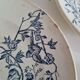 Set of 6 flat plates plus one earthenware dish.
