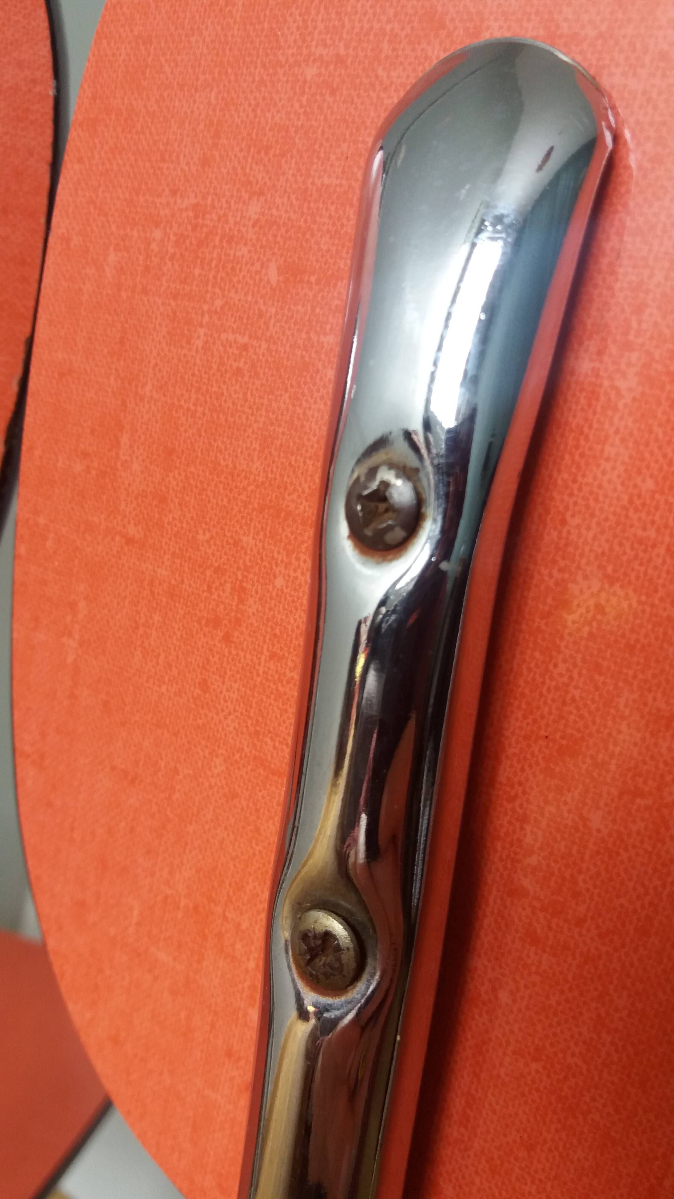 Chairs in red-orange formica and chrome metal.