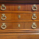 Chest of drawers with decorated handles in the Louis XVI style.