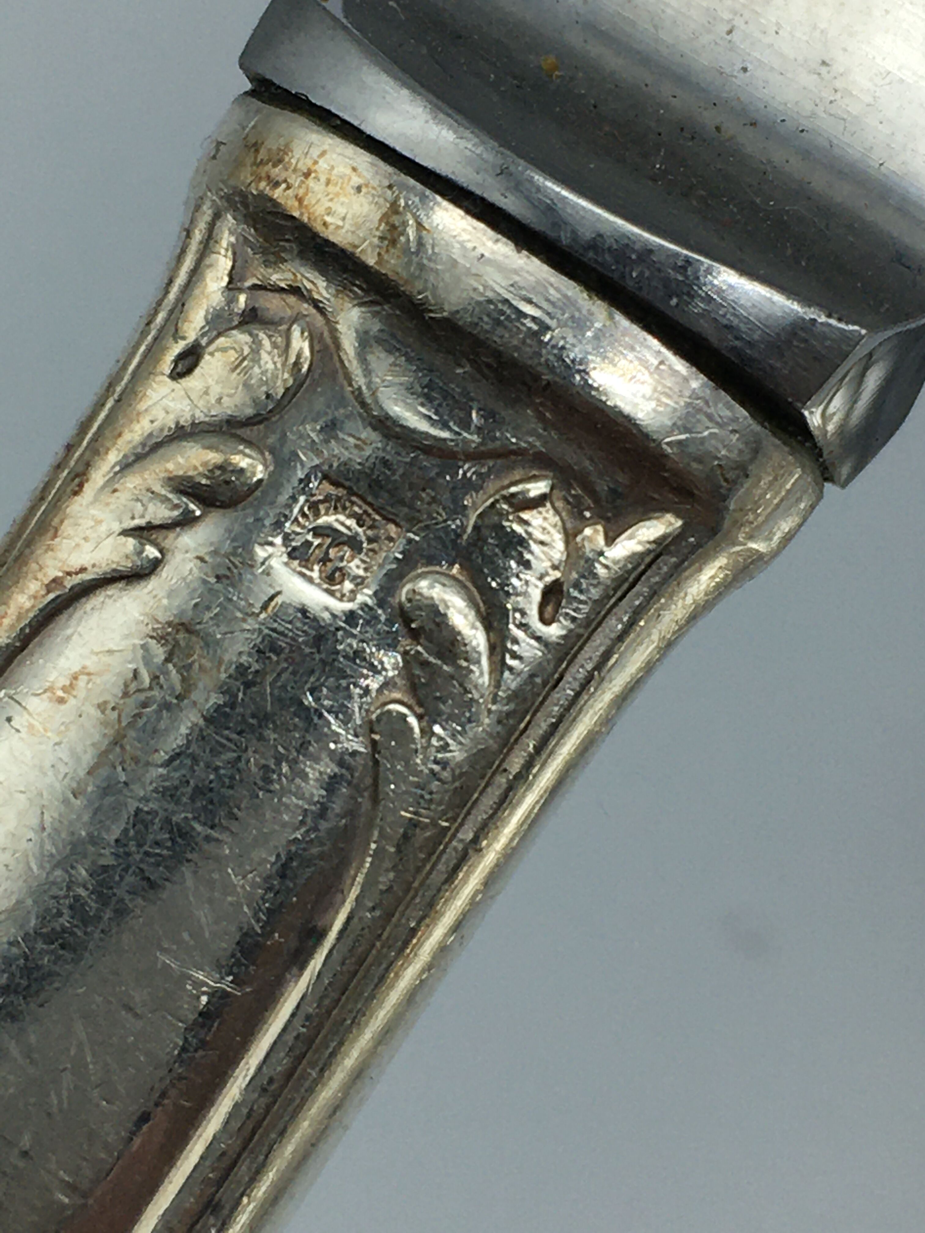 12 silver metal knives.