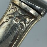 12 silver metal knives.