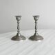 Pair of small metal candle holders, classic design.