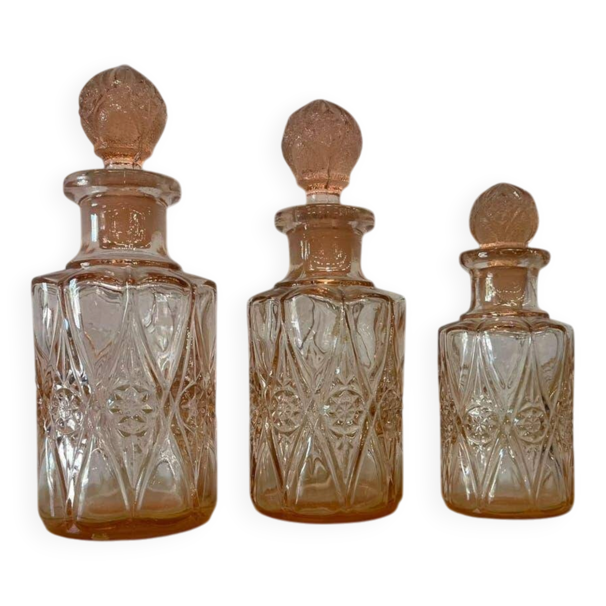 Set of 3 vintage pink glass bottles with corks.