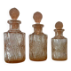 Set of 3 vintage pink glass bottles with corks.
